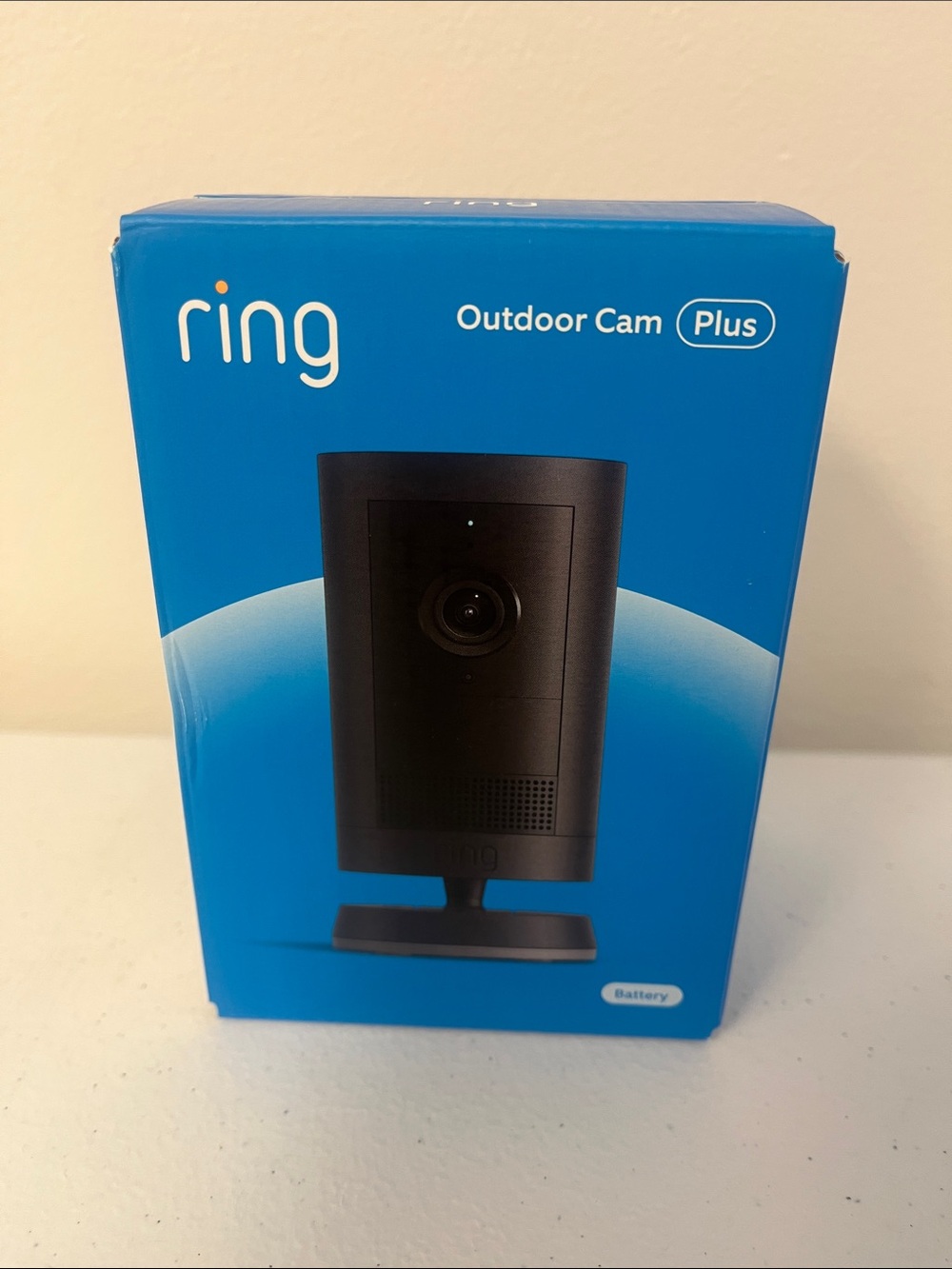 Ring Outdoor Cam Plus in black and blue packaging